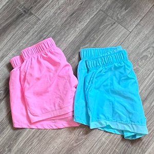 Bright pink or sky blue dri-fit running shorts with pockets and panty liner.